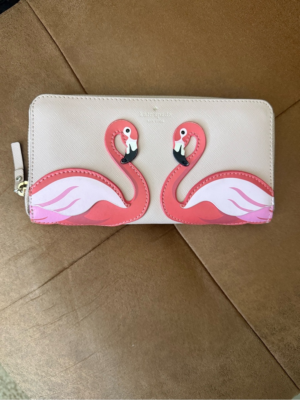 kate spade beige zip-around wallet with pink flamingo appliqués
